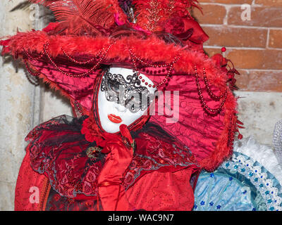 Lady and gentleman in red and white masks, Venice Carnival