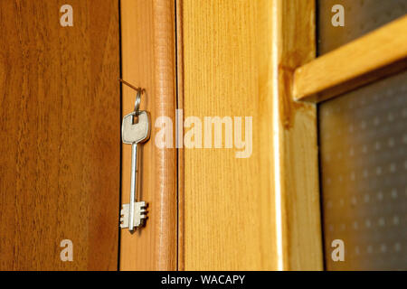 The key hangs on a nail near the door Stock Photo