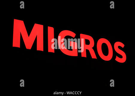 Lugano, Ticino, Switzerland - 26th July 2019 : Picture of the Illuminated Migros sign. The Migros company is the biggest retail and wholesale company Stock Photo
