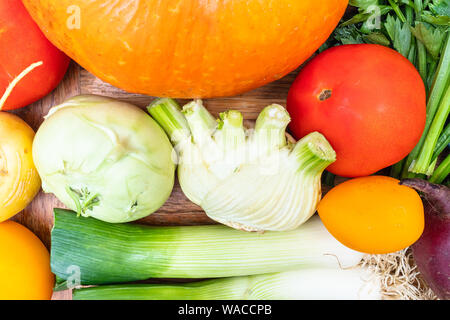 several fresh ripe vegetables on wooden table Stock Photo