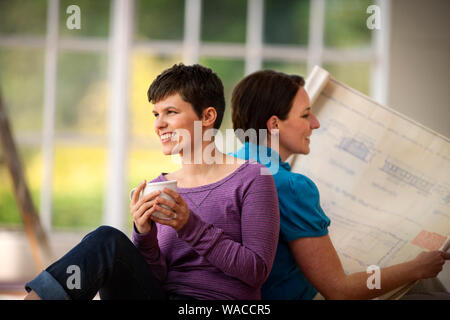 Mid adult couple bonding in their new home. Stock Photo