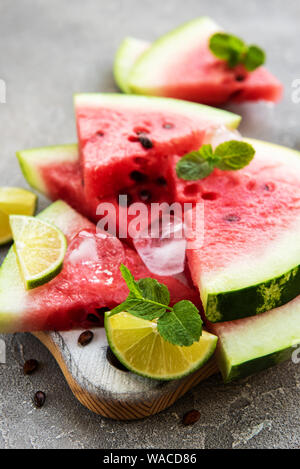 Watermelon with ice on a concrete background Stock Photo - Alamy