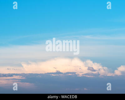 blue sunset sky with low dark gray, pink and white cloud in summer evening Stock Photo
