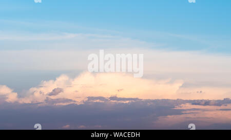 panoramic view of blue sunset sky with low dark gray, pink and white cloud in summer evening Stock Photo