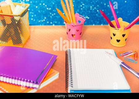 close-up of multicolored containers with pencils and markers for drawing and writing in a notepad Stock Photo