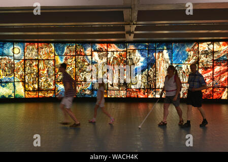 Montreal, Quebec, Canada - Aug 23, 2016: Artwork inside the Montreal metro while a tourist family is passing by Stock Photo