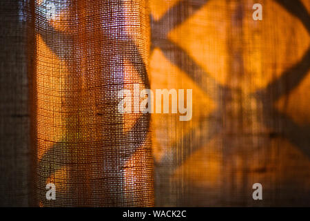 Curtains on the window, on which falls the shadow of the lattice Stock Photo