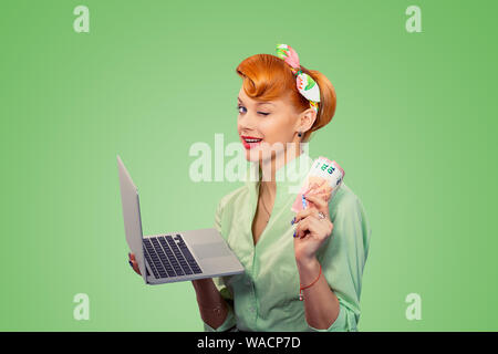 On-line job, internet lottery winner. Closeup red head beautiful young woman girl excited smiling pinup girl in button shirt holding pc and euro bills Stock Photo