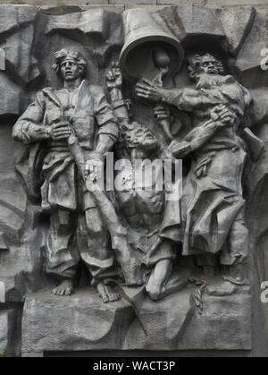 Raskolniki (Old Believers) who worked at the Yekaterinburg iron-making plant depicted in the large scale metal relief entitled 'The Birth of the City' in Yekaterinburg, Russia. The concrete high relief devoted to the history of the city was designed by Russian sculptor Pyotr Sharlaimov and unveiled in 1923 for the first time on the dam of the City Pond (Plotinka). In 1960, the relief was removed and destroyed. It was reconstructed and unveiled again in the 1980s. In 2017, the concrete relief was replaced by the metal one. Stock Photo