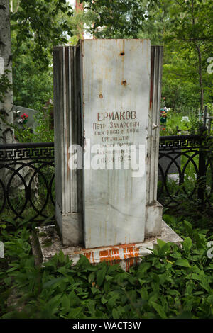 Grave of Russian Bolshevik revolutionary Pyotr Yermakov (1884 - 1952) at Ivanovskoye Cemetery in Yekaterinburg, Russia. He is notable as one of the persons responsible for the execution of the Romanov family in Yekaterinburg in July 1918, including the deposed Tsar Nicholas II, his wife, their children, and their retinue. According to his own memories, he personally killed Tsar Nicholas II and his wife. The gravestone was vandalized by the symbolical bullet holes and bloody red paint in the 1980s. Stock Photo