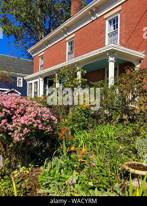 Kittery, Maine / USA - Oct 16, 2018: Typical traditional Victorian waterfront home with covered porch and an English garden. Water Street Inn. Stock Photo