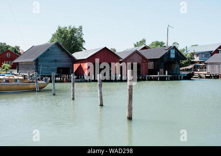 traditional Scandinavian boat houses at a harbour in summer in Finland Stock Photo