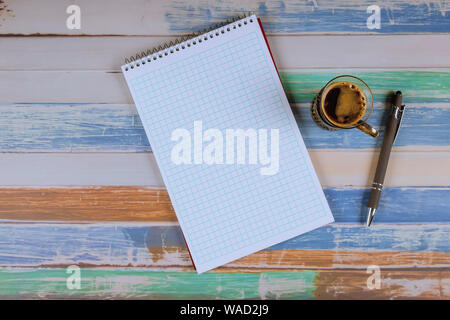 Notepad and pens with espresso coffee on the table. Stock Photo