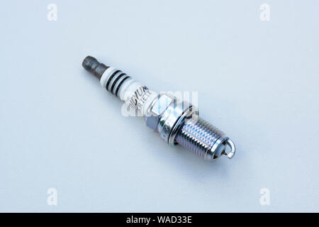 A single new spark plug for a modern petrol combustion engine Stock Photo