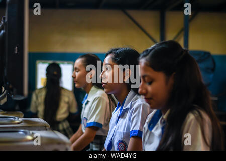 latin female students working on computers at college in Guatemala Stock Photo