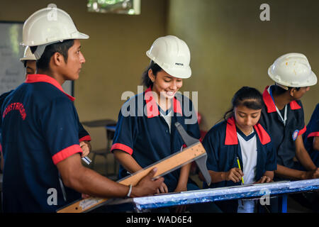 male and female students working on project in Guatemalan school Stock Photo