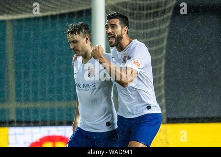 Italian football player Graziano Pelle, right, of Shandong Luneng Taishan celebrates with Brazilian football player Roger Krug Guedes, known as Roger Stock Photo