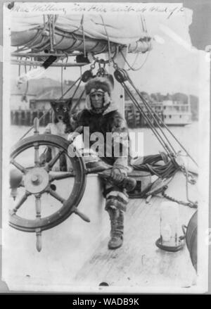 Donald MacMillan in fur suit at wheel of ship Bowdoin Stock Photo