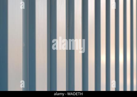 Vertical lines on a corrugated metal surface. Abstract pattern. Stock Photo