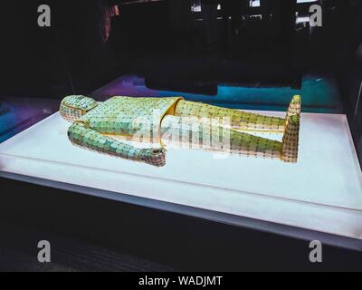 Visitors view a jade-plated suit dating back to the Han Dynasty (206 B.C.-220 A.D.) at a museum in Xuzhou city, east China's Jiangsu province, 11 July Stock Photo