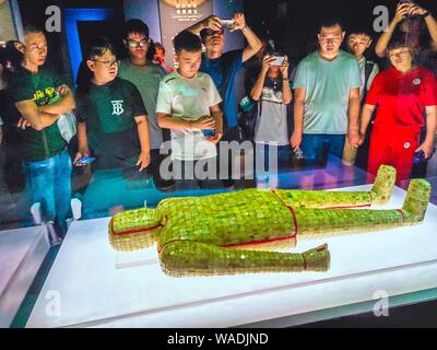 Visitors view a jade-plated suit dating back to the Han Dynasty (206 B.C.-220 A.D.) at a museum in Xuzhou city, east China's Jiangsu province, 11 July Stock Photo