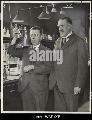 Dr. Alexander Gettler, toxicologist and forensic chemist, and Dr. Charles Norris, New York City's first chief medical examiner, in a laboratory Stock Photo