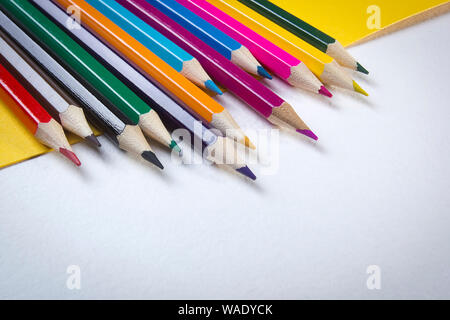 Close-up photo of multicolored pencils on white paper Stock Photo