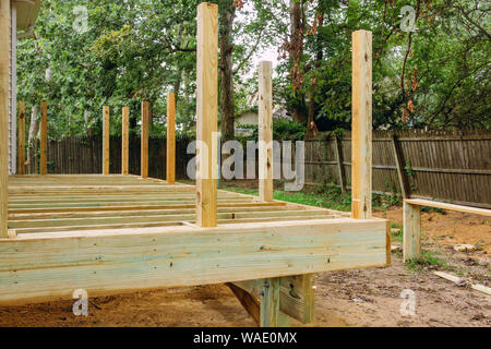 Installing wood floor for patio deck with new wooden decking fragment planks Stock Photo