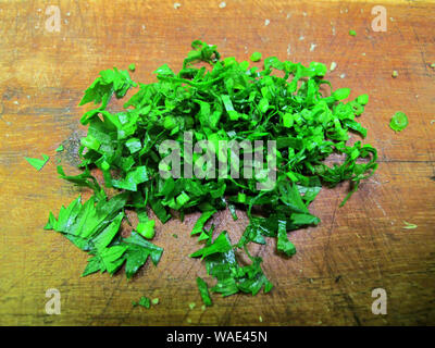 Chopped celery leaves on wooden background Stock Photo