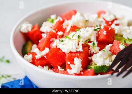 Watermelon, cucumber and feta cheese salad in a white bowl. Stock Photo