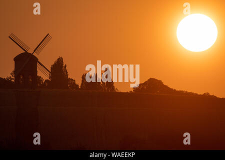 The sun rises over Chesterton Windmill in Chesterton, Warwickshire. Stock Photo