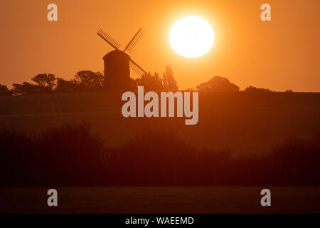 The sun rises over Chesterton Windmill in Chesterton, Warwickshire. Stock Photo