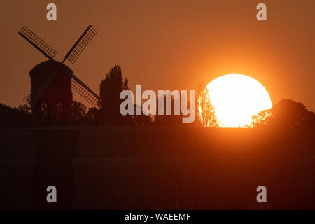 The sun rises over Chesterton Windmill in Chesterton, Warwickshire. Stock Photo