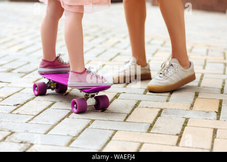 Close up of little girl that going skateboarding Stock Photo