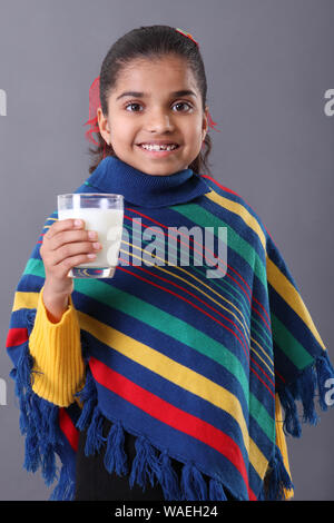 Schoolgirl looking tired while studying Stock Photo