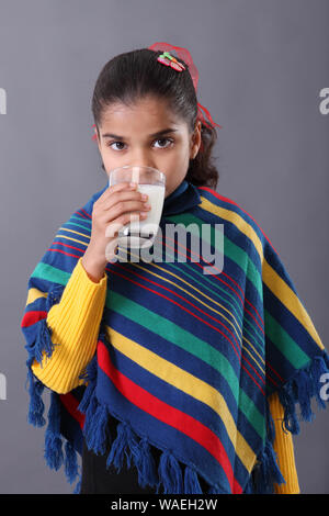 Schoolgirl looking tired while studying Stock Photo