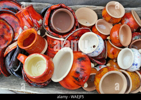 Small  handmade rural ceramic  jugs and cups sold  on a street. Snapshot style image Stock Photo