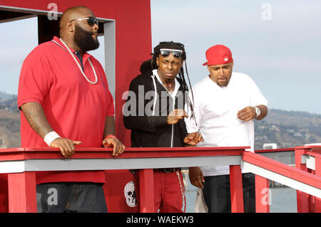 (L-R) Rappers Rick Ross, Lil Wayne and Mack 10 on-set at the Mack 10 ft. Lil Wayne, and Rick Ross 'So Sharp' music video shoot in Malibu. Stock Photo