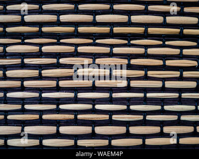 Light brown heavily textured abstract background of women bamboo and black fabric Stock Photo