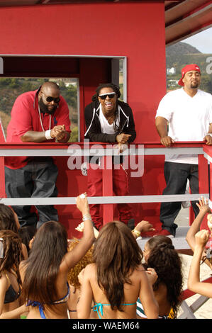 (L-R) Rappers Rick Ross, Lil Wayne and Mack 10 on-set at the Mack 10 ft. Lil Wayne, and Rick Ross 'So Sharp' music video shoot in Malibu. Stock Photo