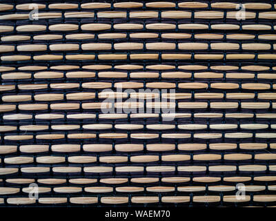 Light brown heavily textured abstract background of women bamboo and black fabric Stock Photo