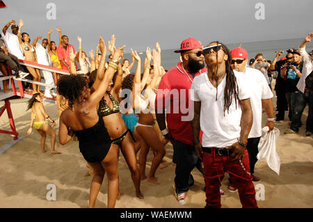 (L-R) Rappers Rick Ross, Lil Wayne and Mack 10 on-set at the Mack 10 ft. Lil Wayne, and Rick Ross 'So Sharp' music video shoot in Malibu. Stock Photo