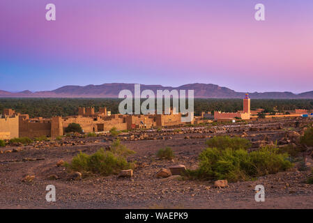 Sunset above a moroccan village with Atlas mountains in the background Stock Photo