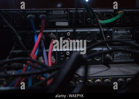 The connectors and the wires leading to the audio apparatus in a recording Studio. The workplace of the sound engineer Stock Photo