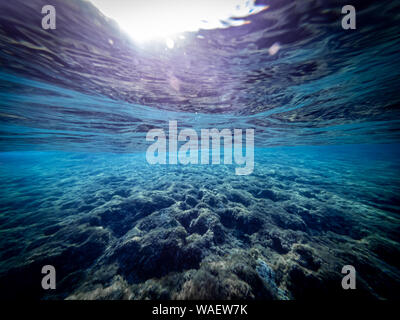 Underwater view of the seabed in San Lorenzo beach, in the southern Sicily, Italy. The shot is taken during a sunny summer day, with rays of light co Stock Photo