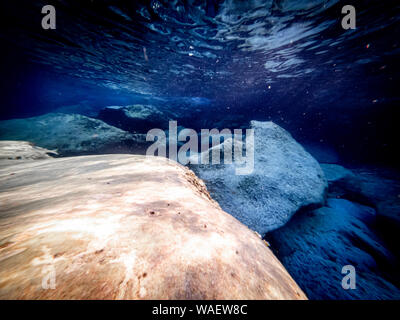 Underwater view of the seabed in San Lorenzo beach, in the southern Sicily, Italy. The shot is taken during a sunny summer day, with rays of light co Stock Photo