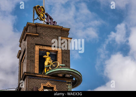 Woman with a bicycle, a sclulpture at the top of Rich house tower, Copenhagen, August 16, 2019 Stock Photo