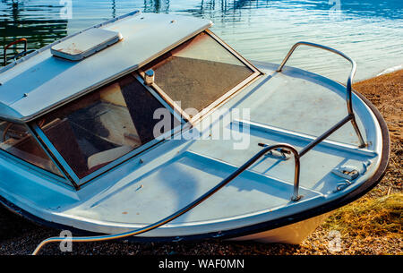 North macedonia. Ohrid. Old broken boat on stone shore.