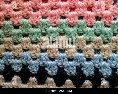 Striped crochet fabric in bright colours, detail of a blanket Stock Photo