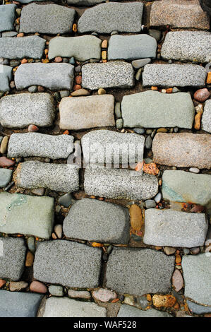 Large stones and small pebbles making up section of seawall Stock Photo